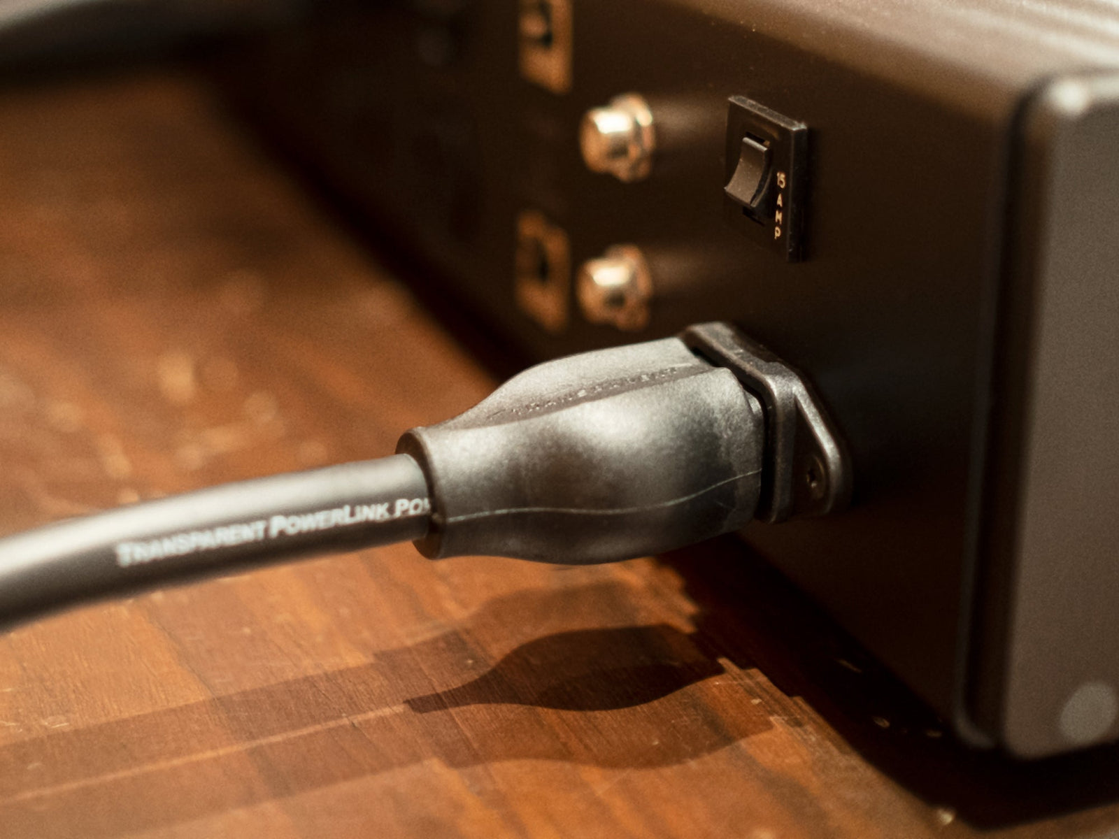 A close up image of a power cord connected to a device.