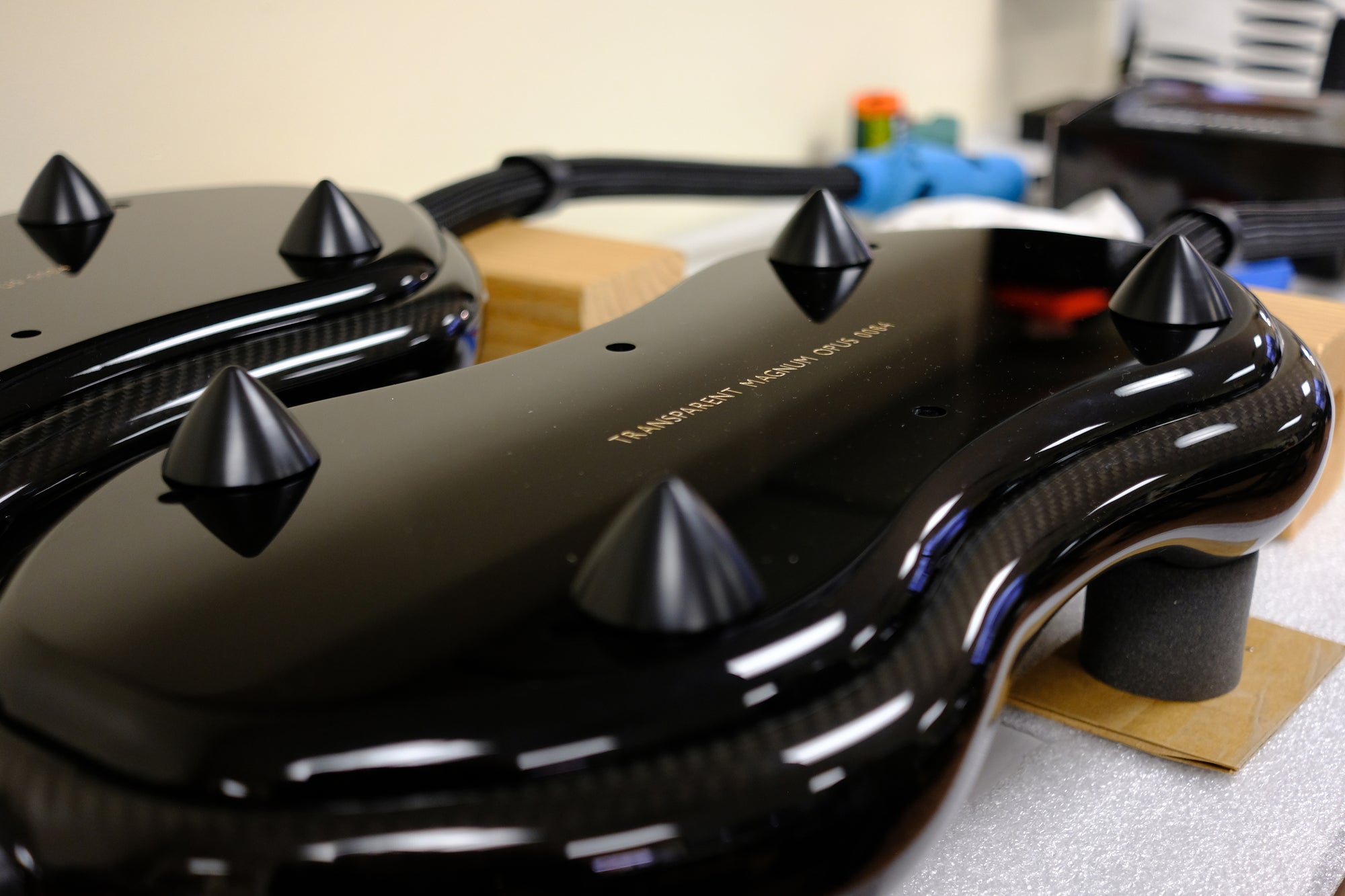 Two black gaming controllers with spikes on them.