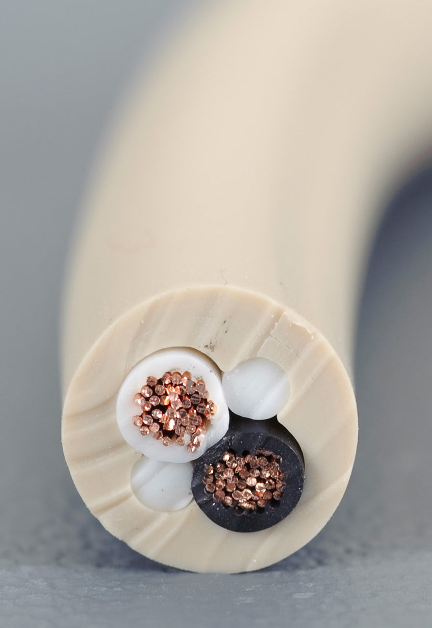 A close up of a white cable with copper wires.