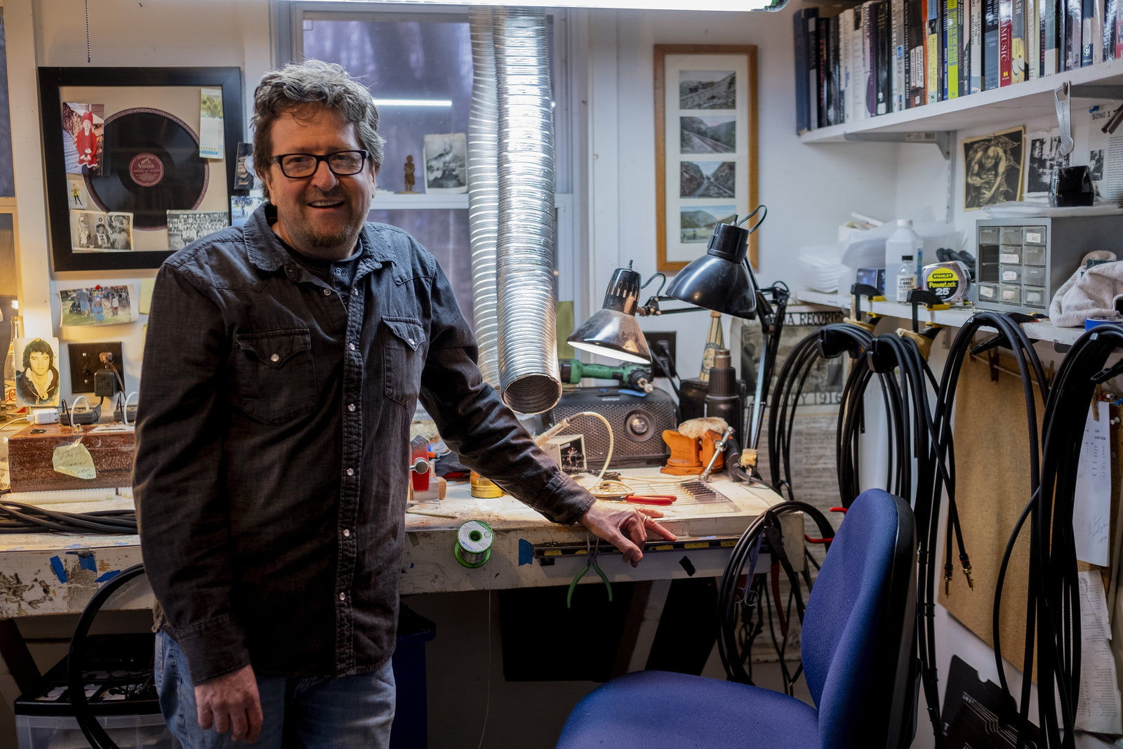 A man standing in front of a desk.