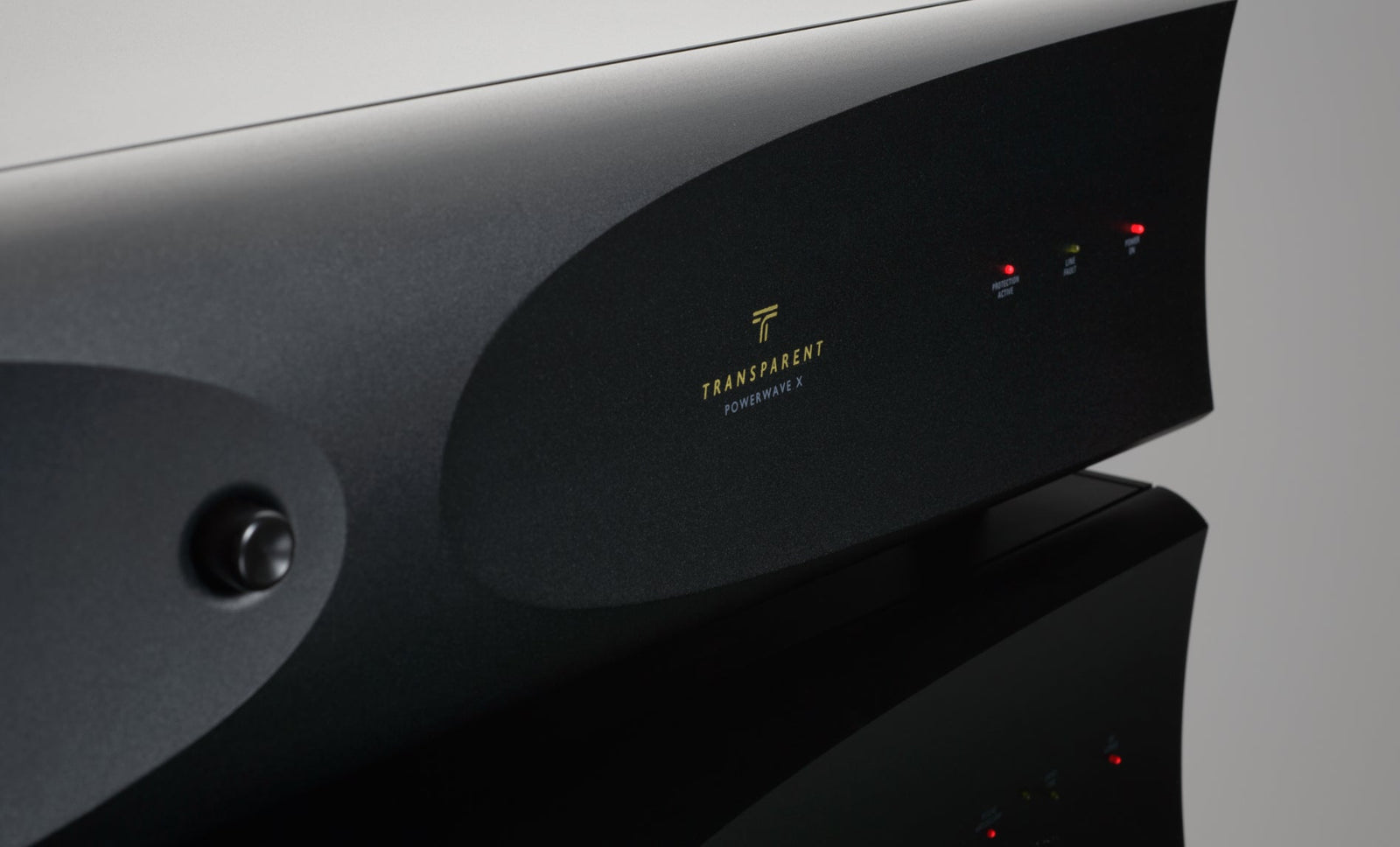 A black amplifier with a red light on it.