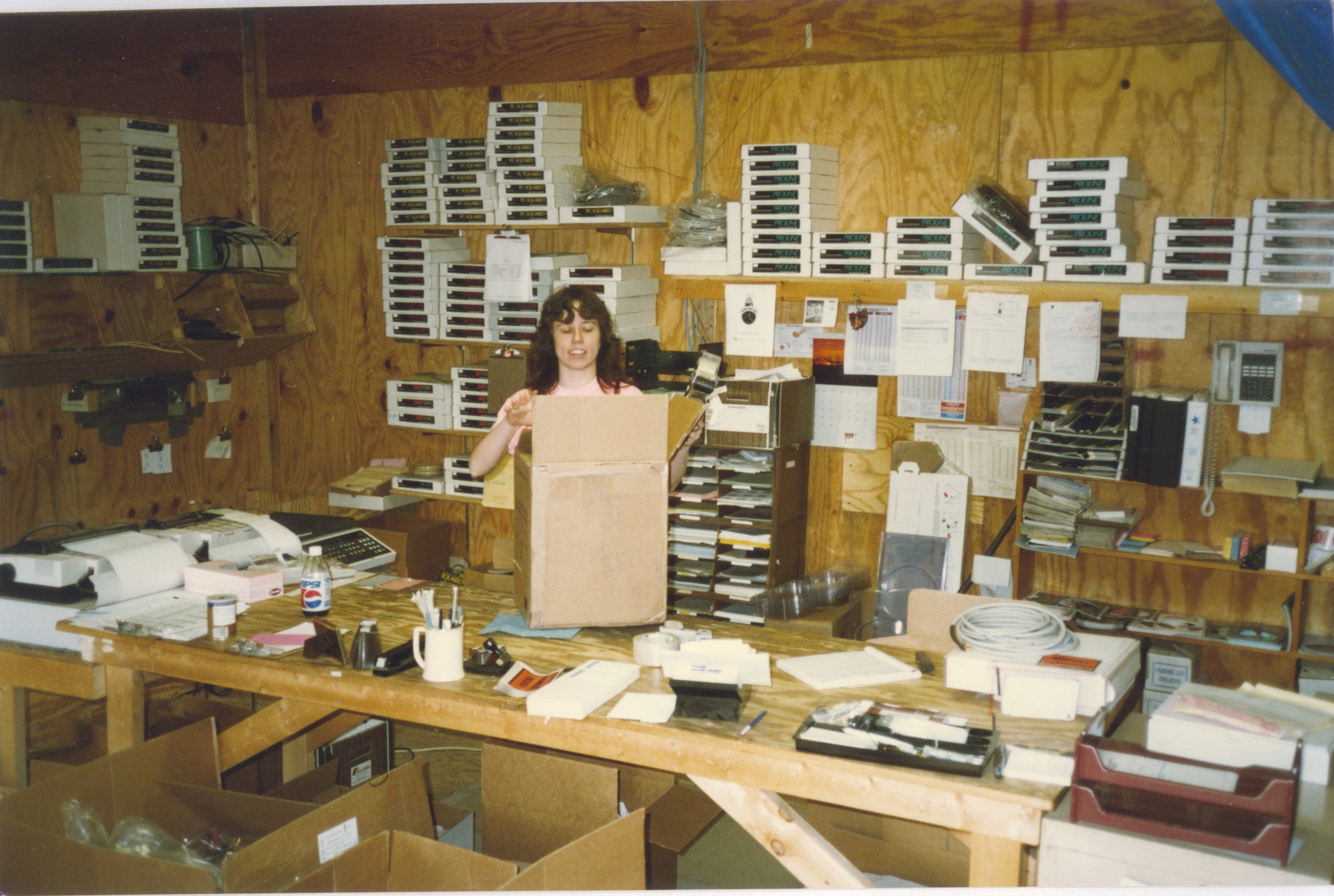 A woman standing in front of a box.