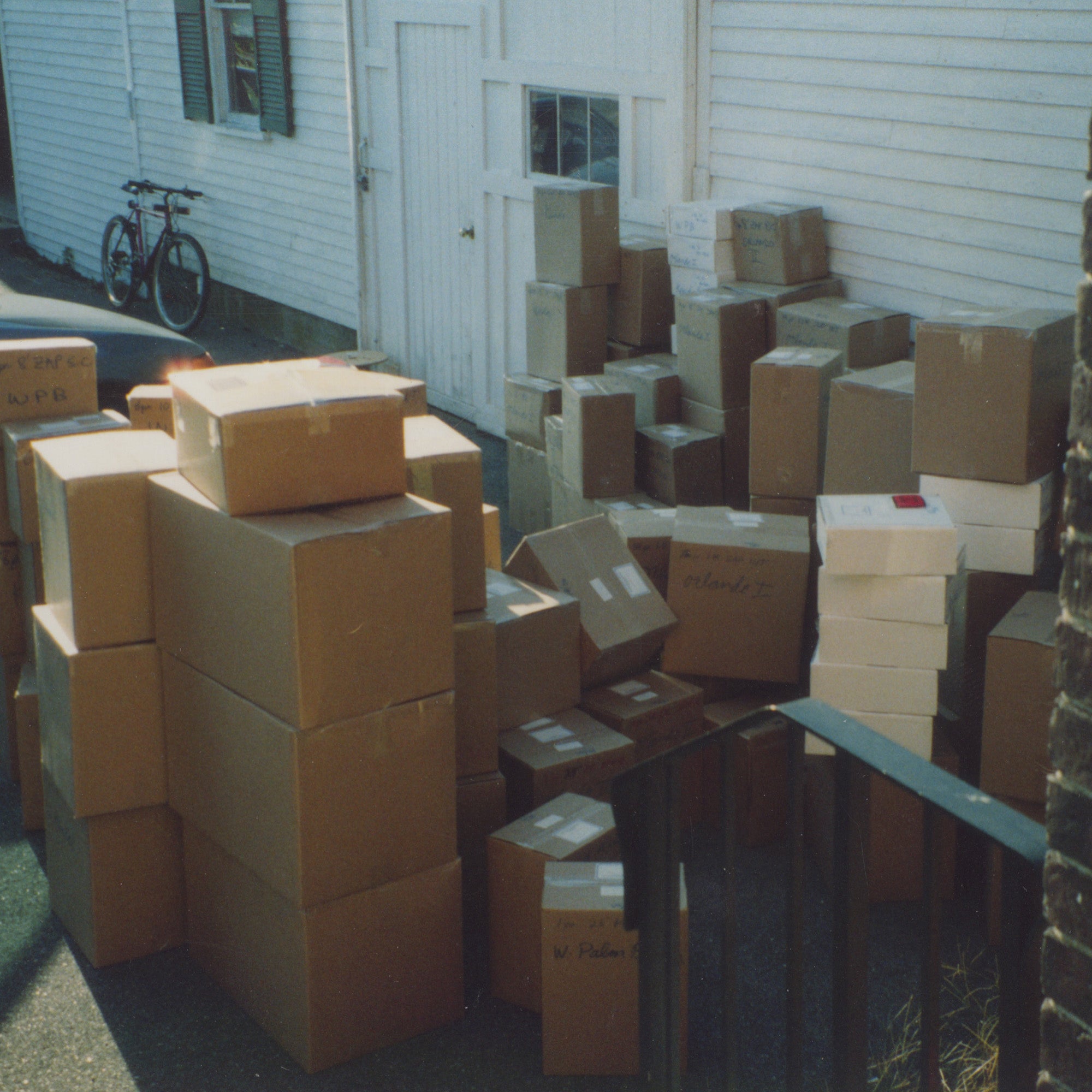 A stack of boxes in front of a house.