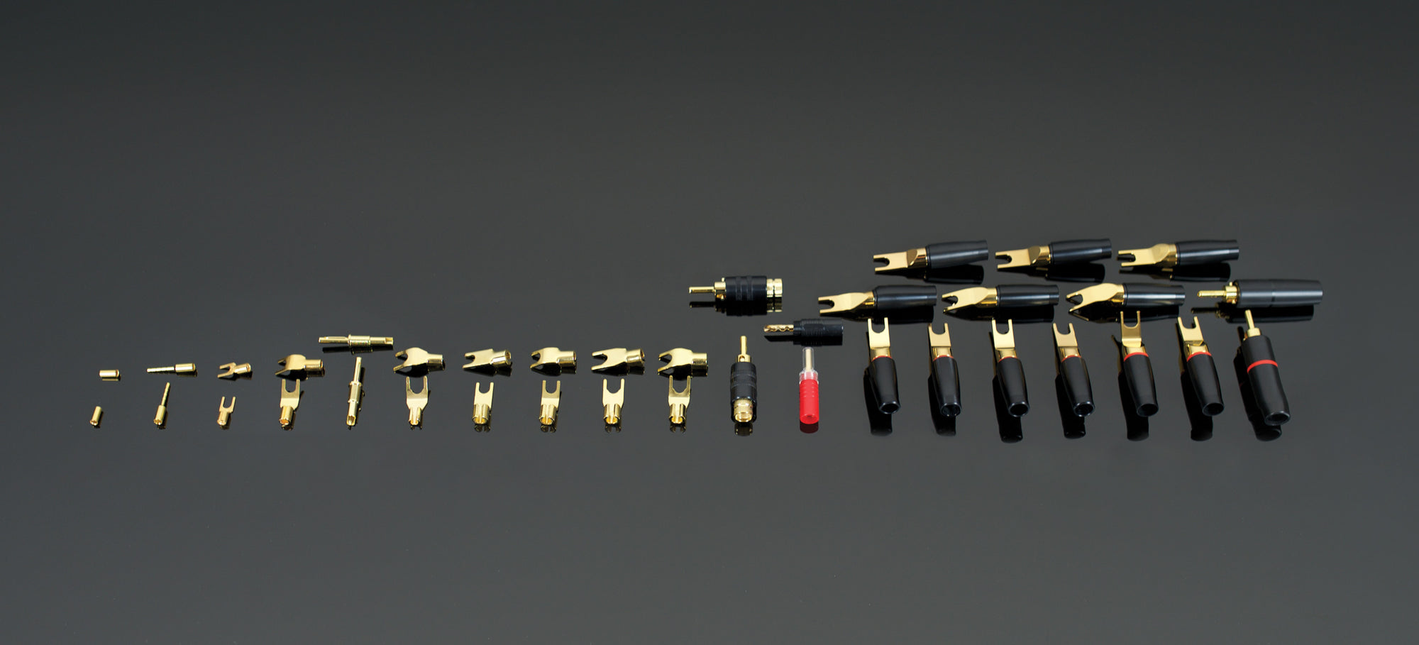 A group of black and gold tools on a black surface.