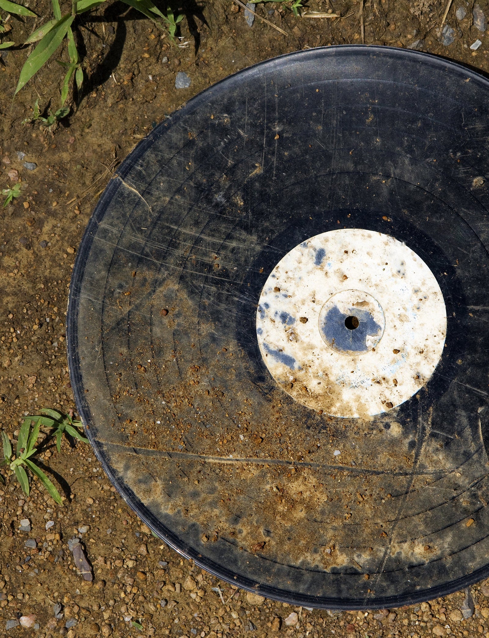 A black and white record lying on the ground.