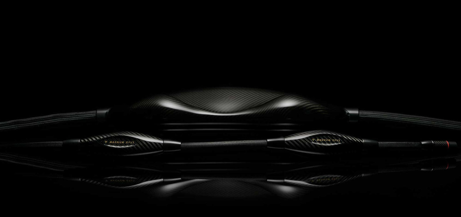 A black earphone sitting on a black surface.