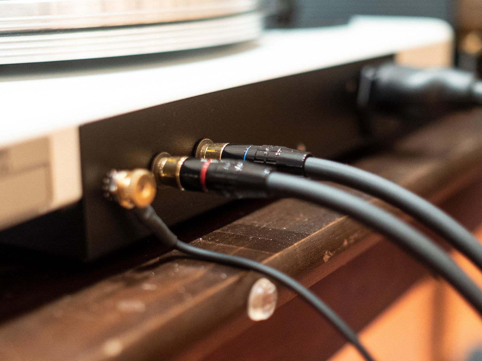 A turntable with two cables connected to it.