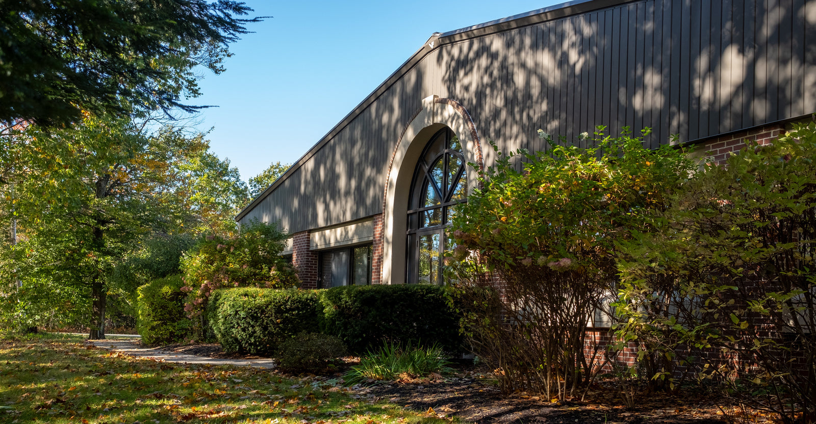 A building with trees and bushes.