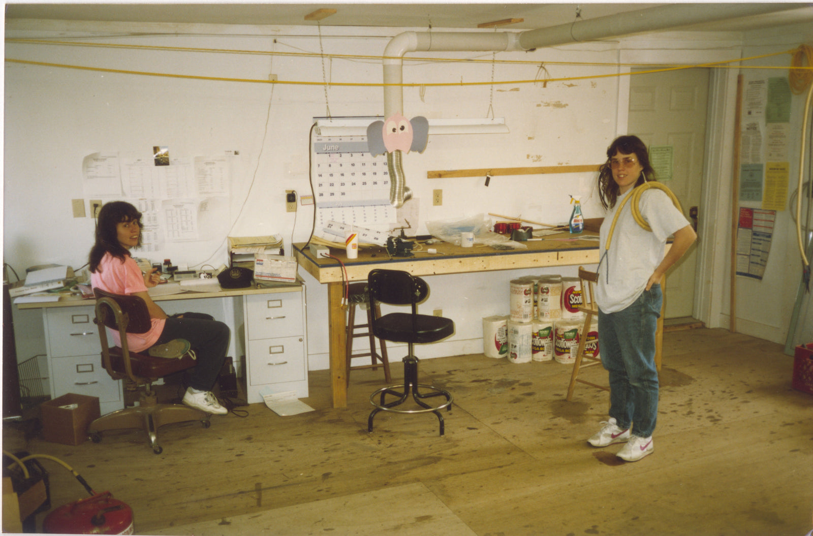 Two women standing in a room.