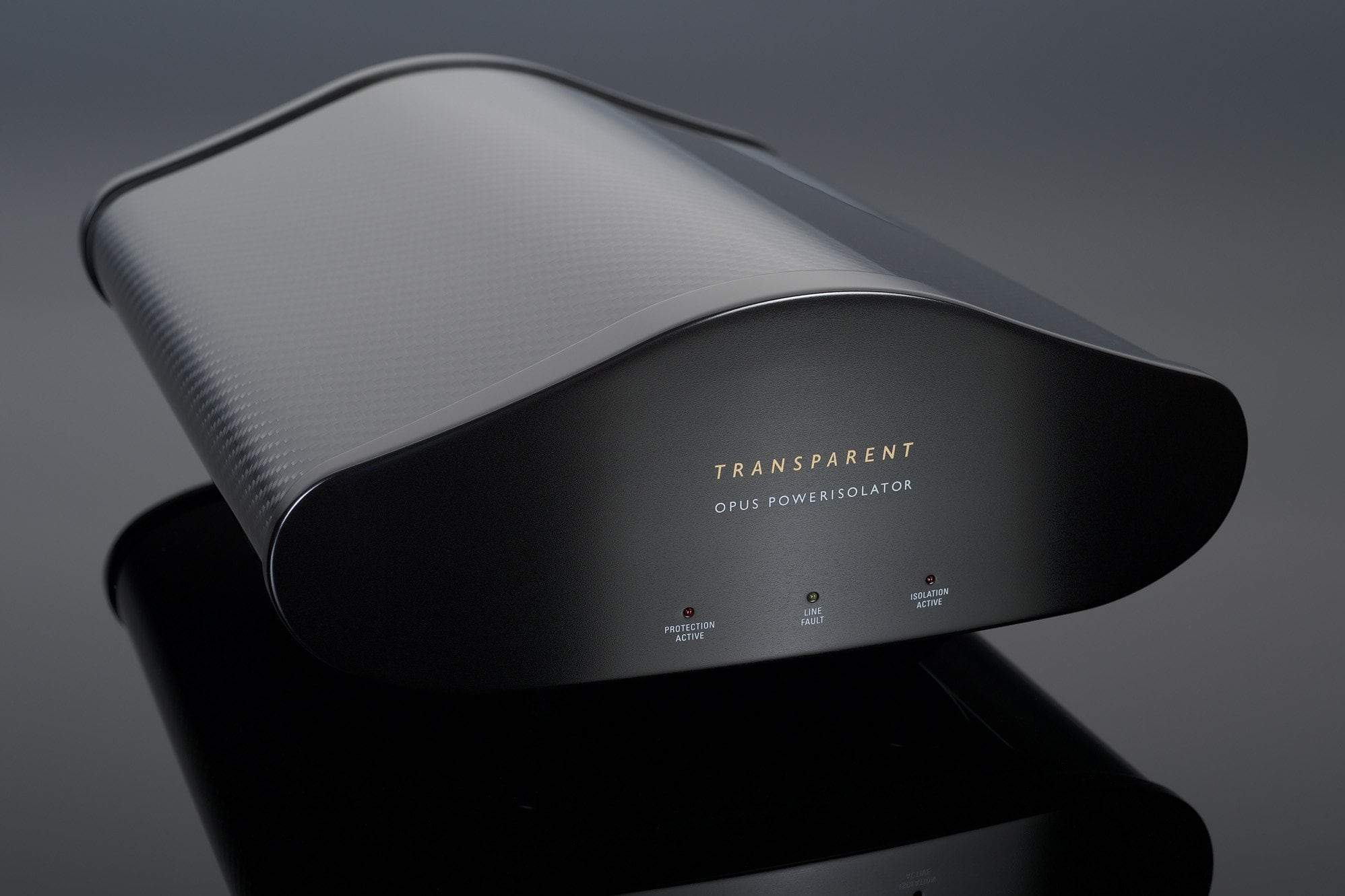 A sleek, black Transparent Audio OPUS PowerIsolator Generation 5 device, featuring indicator lights for protection active, line fault, and ground fault, rests on a reflective surface, ensuring noise-free power.