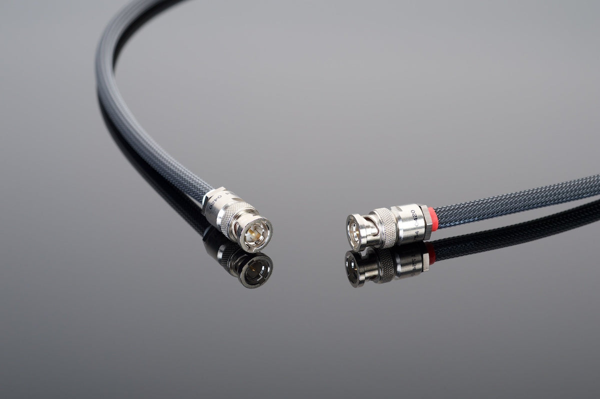 A high-quality coaxial cable with connectors on both ends from Transparent Audio&#39;s Premium 75-Ohm Digital Link series is displayed on a reflective surface.